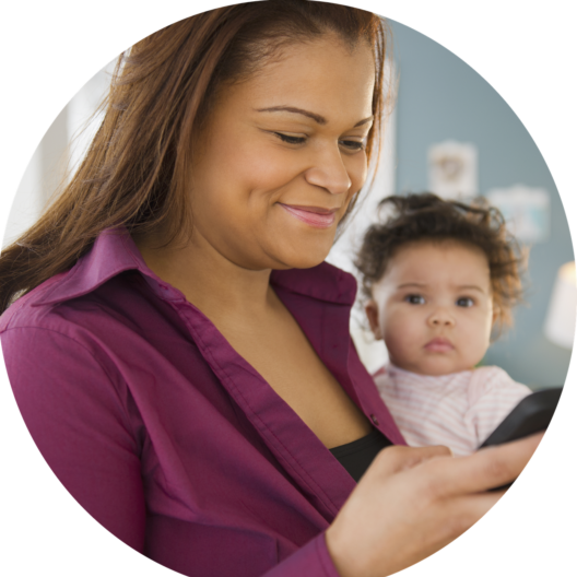 Woman holding phone and baby